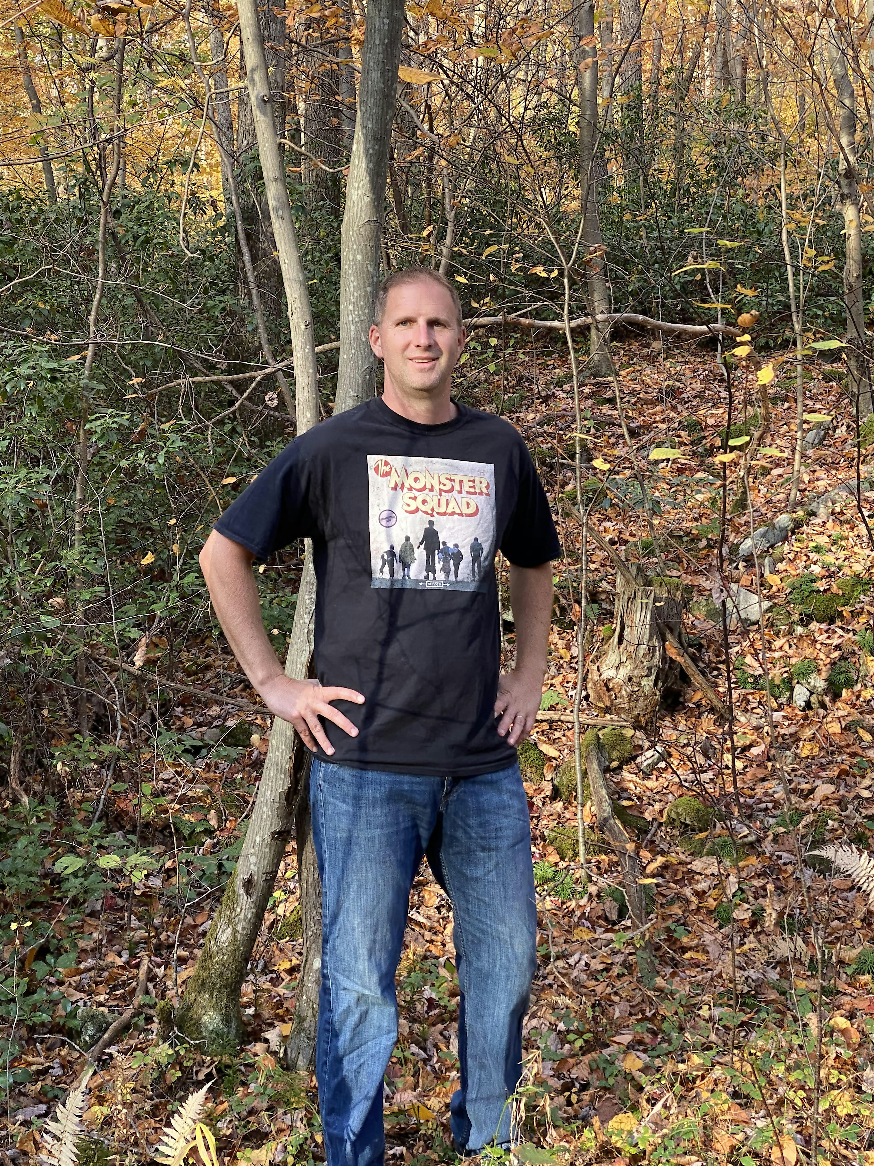 Kevin Stecko, founder of 80sTees.com, wearing the Soundtrack Monster Squad T-Shirt in a forest setting